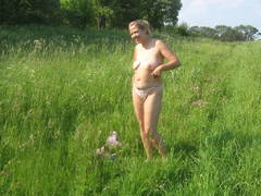See my wife's bare photos posing in the open air sitting on my car and on the meadow. Image 9